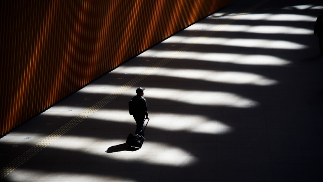 Man walking suitcase shadow backlighting free wallpaper - medium preview image