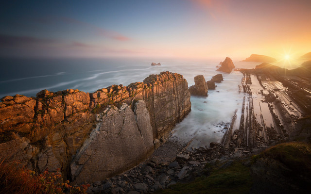 Rocky cliff water sunset mountains free wallpaper - medium preview image