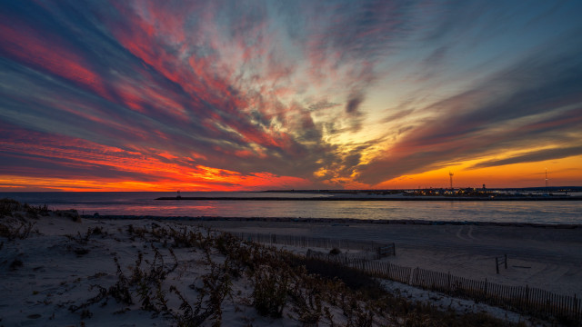 Sunset beach fence lighthouse cityscape free wallpaper - medium preview image