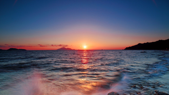 Sunset ocean boat mountain sky free wallpaper - medium preview image