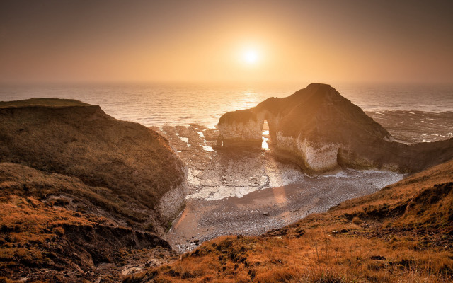 Sunset ocean rocky outcropping beach free wallpaper - medium preview image