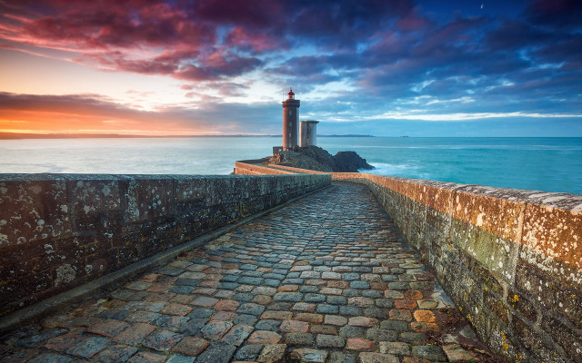 Stone lighthouse rocky shore sunset free wallpaper - medium preview image