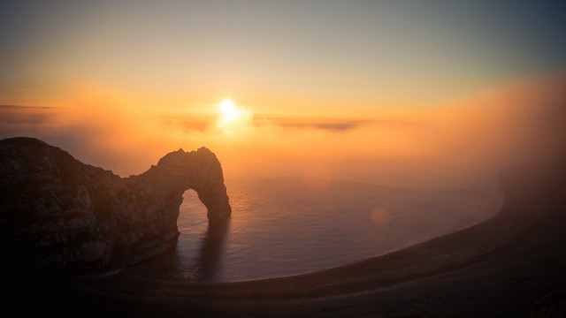 Sunset foggy mountain arch volumetric free wallpaper - medium preview image