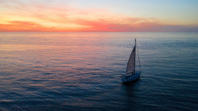 Sailboat ocean sunset red yellow free wallpaper - medium preview image