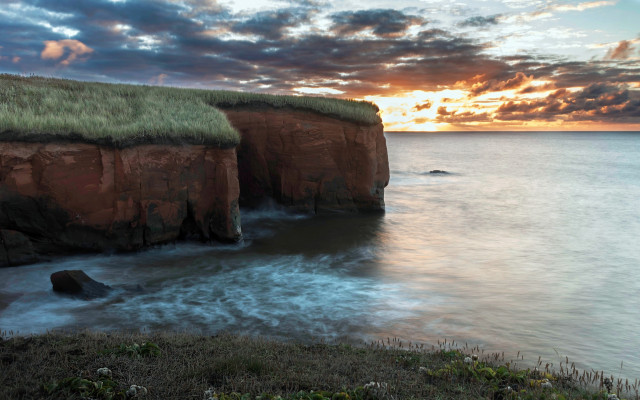 Grassy roof cliff ocean sunset free wallpaper - medium preview image