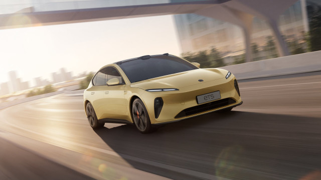 Yellow car driving bridge buildings free wallpaper - medium preview image