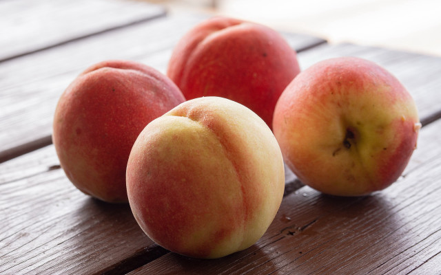 Three peaches wooden table middle free wallpaper - medium preview image