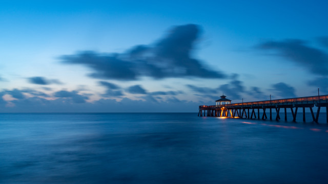 Pier lighthouse night clouds water free wallpaper - medium preview image