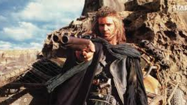 Man holding gun mountain sky free wallpaper - medium preview image