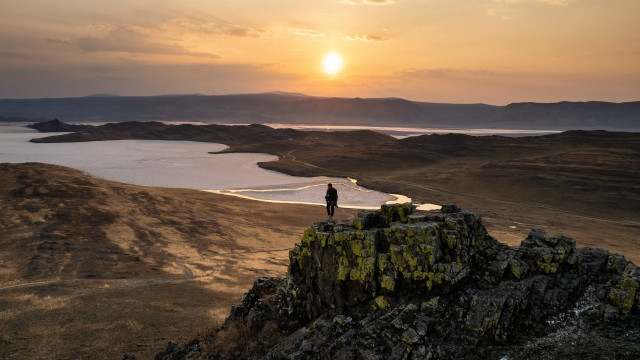 Person rock overlooking lake mountains free wallpaper - medium preview image