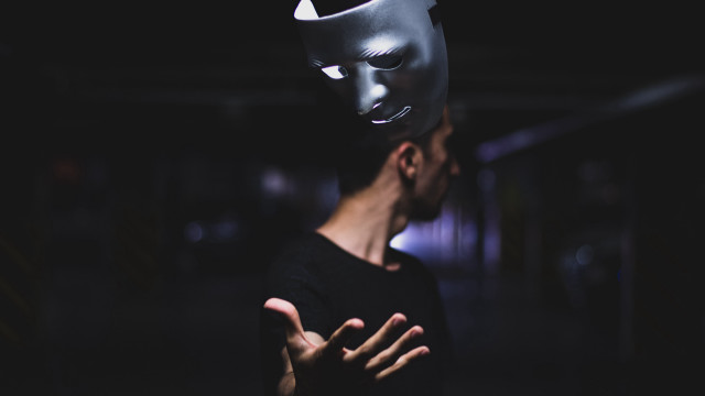 Masked man hands out dark free wallpaper - medium preview image