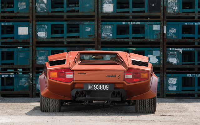 Red sports car parked crates free wallpaper - medium preview image