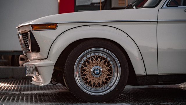 White car brown rim garage free wallpaper - medium preview image