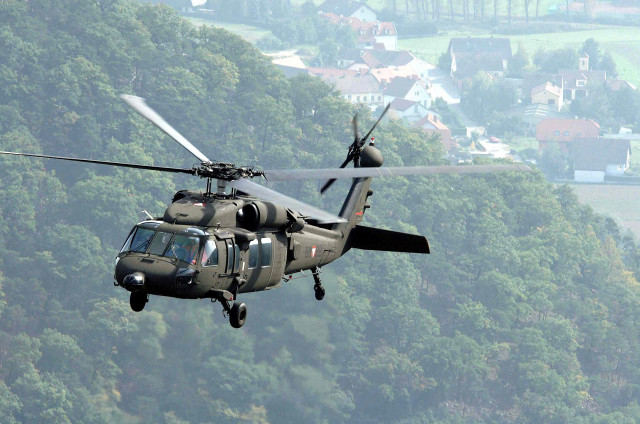 Helicopter flying lush green hillside #2 free wallpaper - medium preview image