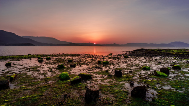 Sunset over water rocks and free wallpaper - medium preview image