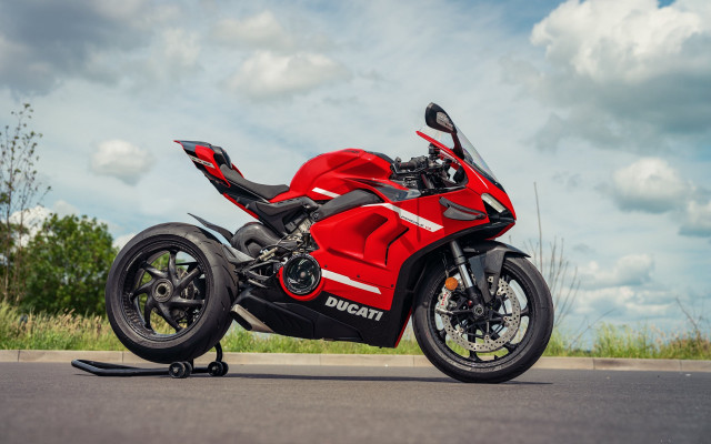 Red motorcycle green field cloudy free wallpaper - medium preview image