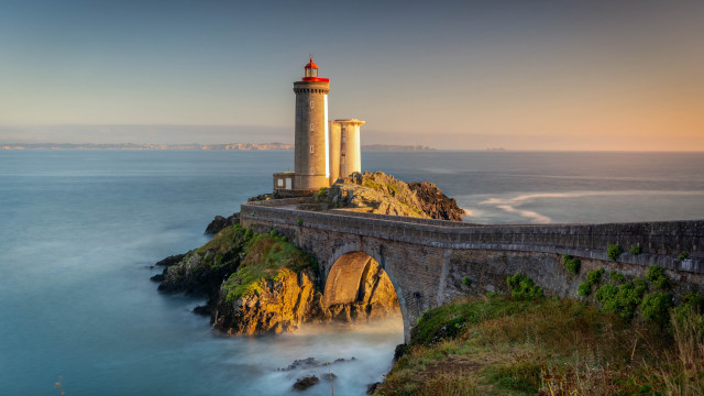 Lighthouse cliff bridge ocean sunset free wallpaper - medium preview image