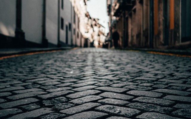 Cobblestone street stop sign tiltshift free wallpaper - medium preview image