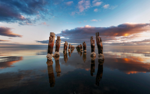 Wooden posts water sunset clouds free wallpaper - medium preview image