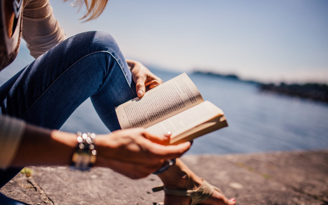 Woman reading by water beach free wallpaper - medium preview image
