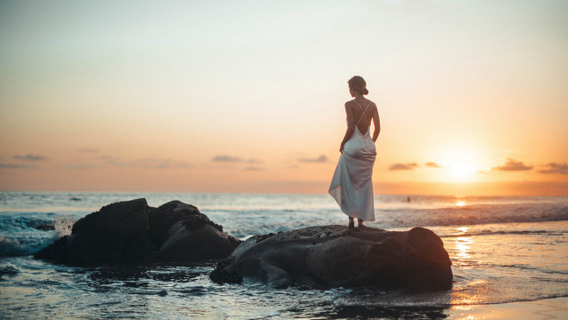 Woman ocean rock sunset beach free wallpaper - medium preview image