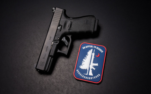 Gun patch black surface red free wallpaper - medium preview image