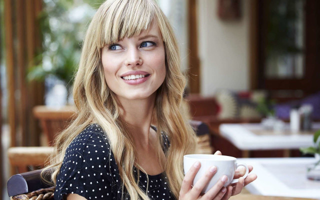 Woman smiling coffee table blur free wallpaper - medium preview image