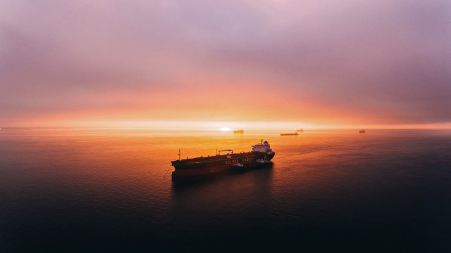 Cargo ship ocean sunset mountain free wallpaper - medium preview image