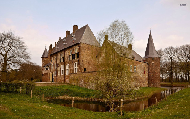 Large brick building towers pond free wallpaper - medium preview image