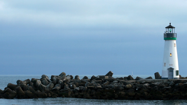 Lighthouse rocky pier water cloudy free wallpaper - medium preview image