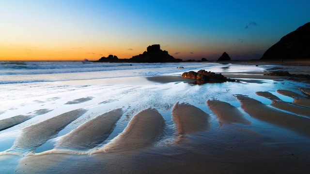 Beach rock formation sunset ocean free wallpaper - medium preview image