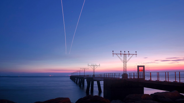 Pier plane sunset contrails water free wallpaper - medium preview image