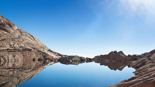 Mountain lake rockface clear sky free wallpaper - medium preview image
