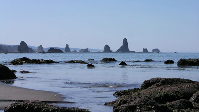 Beach rocks water hill sky free wallpaper - medium preview image