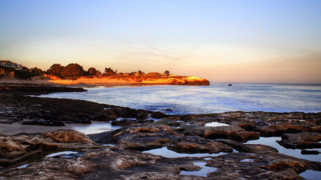 Beach rocky shore houses sunset free wallpaper - medium preview image