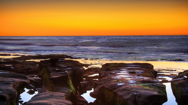 Sunset ocean rocks water beach free wallpaper - medium preview image