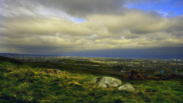Grassy hill rocks city cloudy free wallpaper - medium preview image