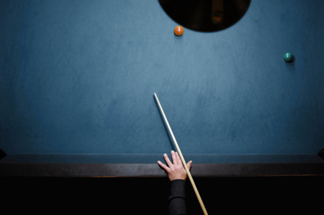 Person holding pool stick table free wallpaper - medium preview image