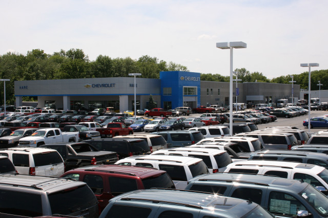 Cars parked building sky trees free wallpaper - medium preview image