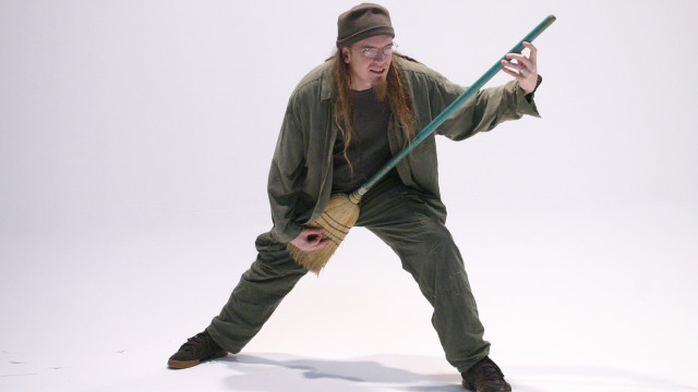 Man green outfit holding pole free wallpaper - medium preview image