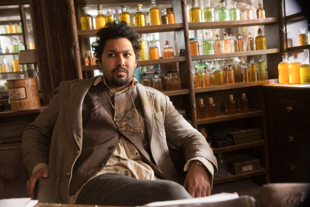 Afrofuturism man sitting bar shelf free wallpaper - medium preview image