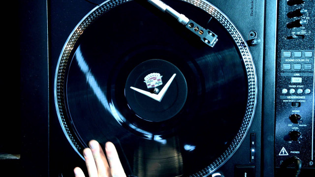 Person holding record player clock free wallpaper - medium preview image