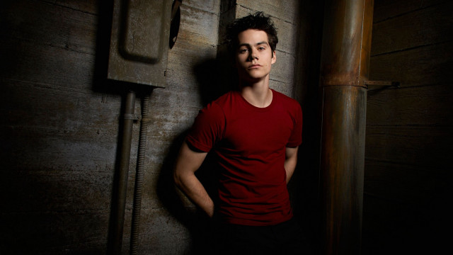 Man red shirt leaning wall free wallpaper - medium preview image