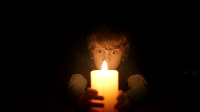 Creepy person holding candle dark free wallpaper - medium preview image