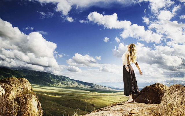 Woman rock formation sky clouds free wallpaper - medium preview image