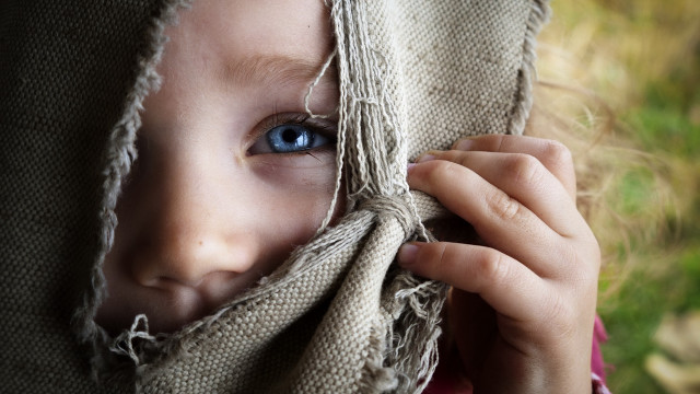Child hiding bluish eyes blanket free wallpaper - medium preview image