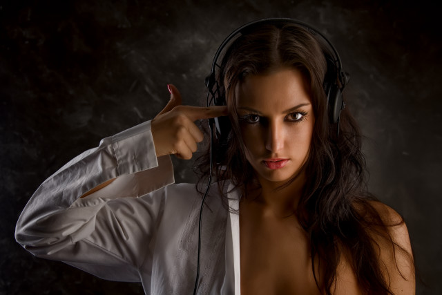 Woman headphones dark room promotional free wallpaper - medium preview image
