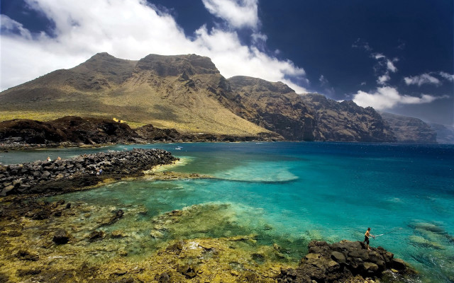 Rocky shore mountain water sky free wallpaper - medium preview image