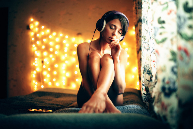 Woman sitting headphones blur bokeh free wallpaper - medium preview image