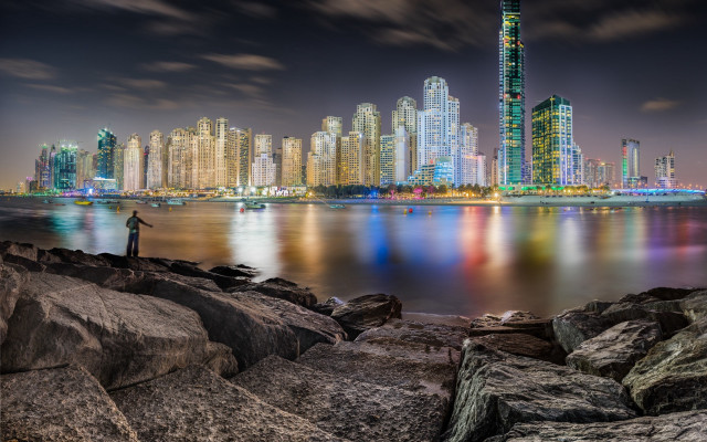 Man rock water city night free wallpaper - medium preview image